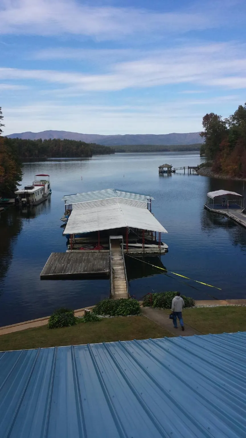 View across a lake from a newly installed blue metal roof in Towson