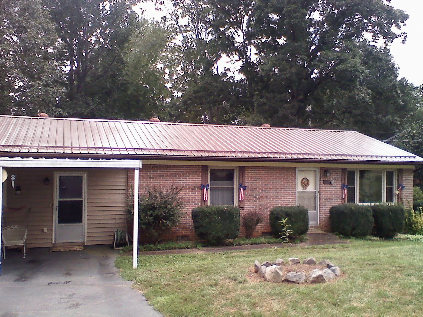 Bronze metal roof and carport on a brick ranch home — Roof Repair work by our crew in Towson