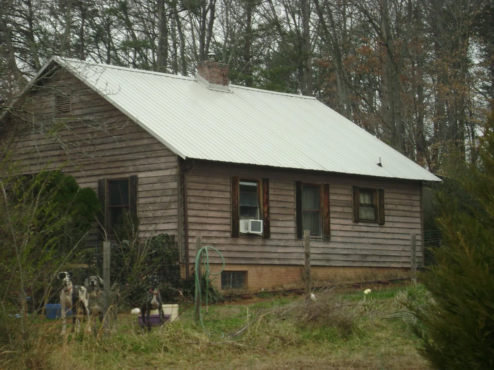 White metal roof on an old wood sided farmhouse, from a Metal Roof Installation job in Towson